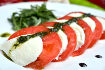 Caprese salad with mozarella cheese, tomatoes and basil