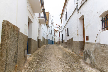 Cobbled street and houses in the town of Aroche, Huelva, Spain