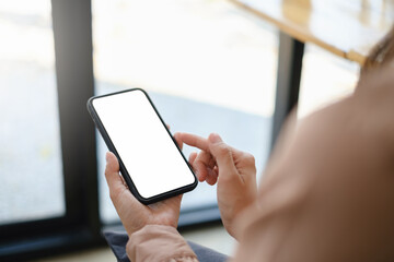 A woman hand holding smartphone device with blank screen.