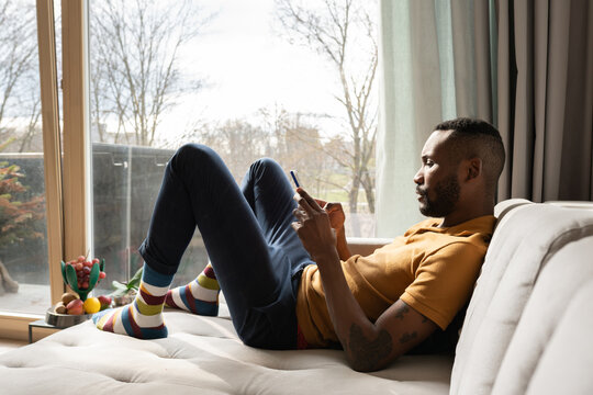 Man Using Phone On Couch