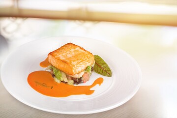 Freshly cooked salmon fillet on a white plate
