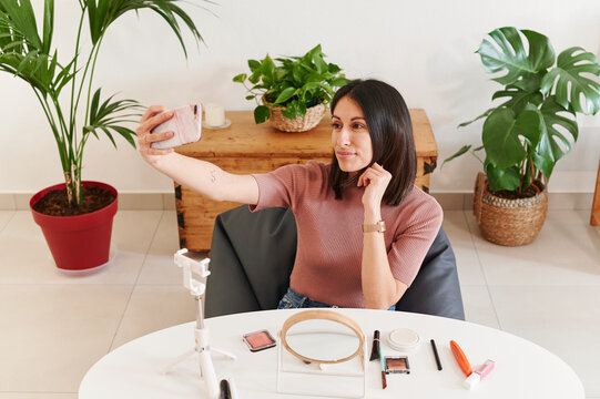 Woman taking a selfe for her beauty vlog
