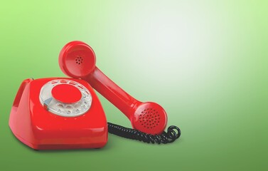 Old, red rotary dial retro telephone with receiver,
