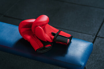 Boxing gloves on bench in gym