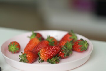 Fresh strawberries on white plate