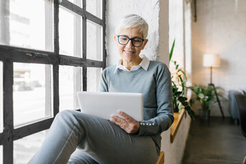 Portrait of a senior businesswoman using her tablet in the office 