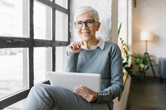 Portrait of a senior businesswoman using her tablet in the office - Powered by Adobe