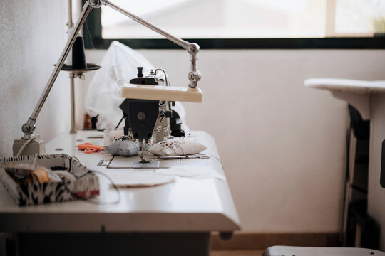 Close-up view of sewing machine in selective focus, workspace concept