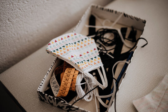 Box with sewing tools and handmade mask