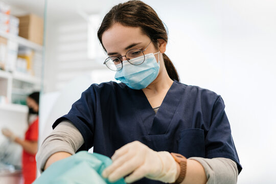 Veterinarian in uniform operating on an animal