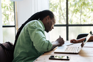 Man freelancer working on laptop at home office