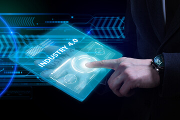 Business, Technology, Internet and network concept. Young businessman working on a virtual screen of the future and sees the inscription: Industry 4.0