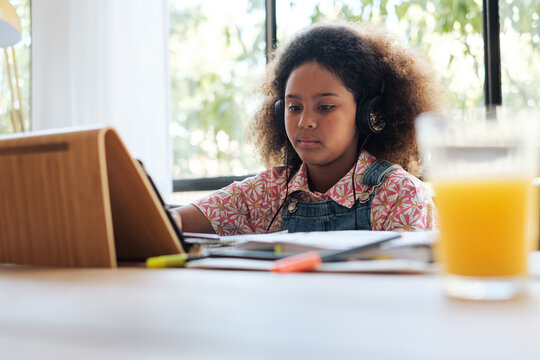 Focused girl studying online at home