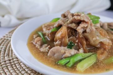 Fried noodle with pork and kale in gravy. Chinese and Thai Style food called "Thai food called Rad Na Moo"