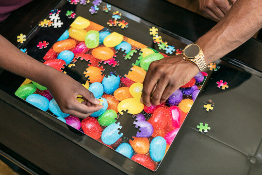 Father And Son Work Together On Fun Puzzle