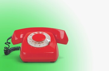 Old, red rotary dial retro telephone with receiver,