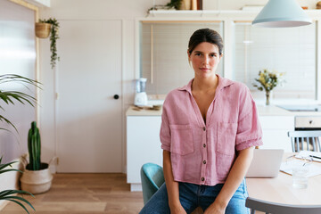 Young woman relaxing on kitchen table