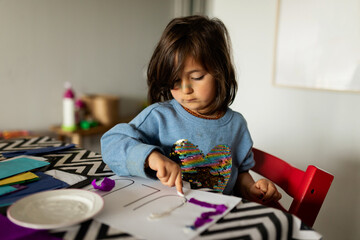 Little kid doing crafts at home