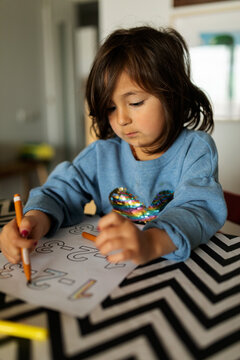 Little child coloring at home