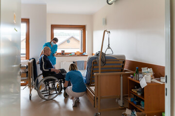 Nurses Attending Patient in Wheelchair
