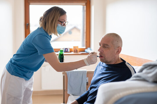 Nurse Providing Medication To Patient 