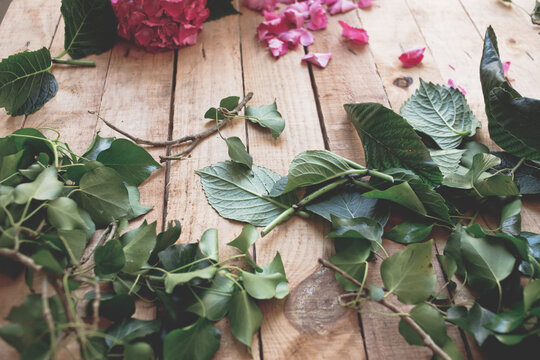 A beautiful arrangement of hydrangea mixed with leaves in a vintage tureen