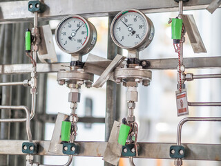 Pressure gauge of measuring instrument close up in industry zone at power plant with closed up