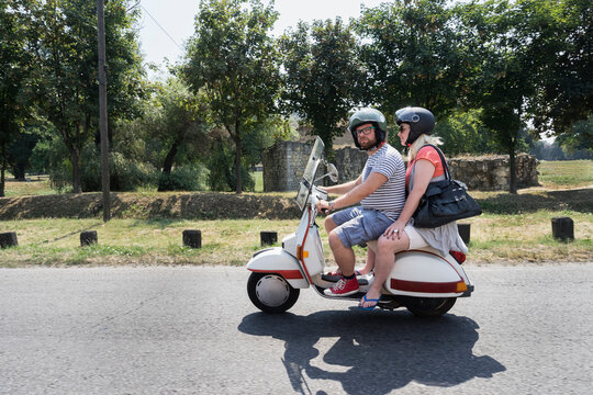 Couple on motor scooter