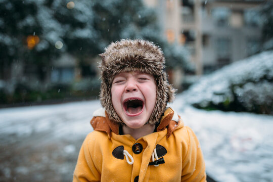A little boy crying in the snow