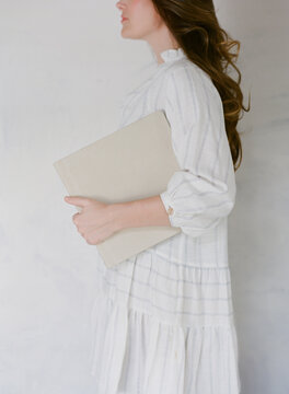 portrait of young woman holding large hardcover book