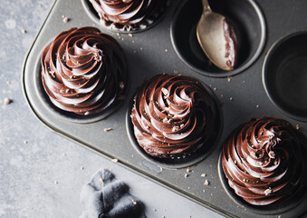 Chocolate cupcakes arranged in a muffin tin