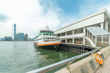 Ferry and pier in Victoria harbor in Hong Kong city