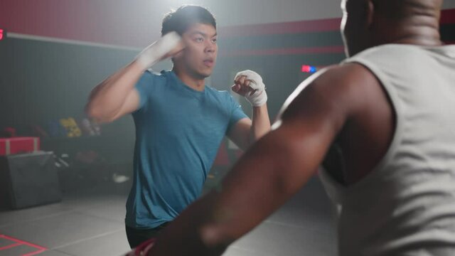 Fitness boxer trainer motivate sportsman exercise boxing, punch at gym	
