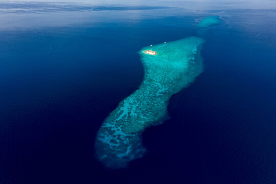 Aerial view of a lighthouse on the island. Amazing beach with a turquoise and transparent sea