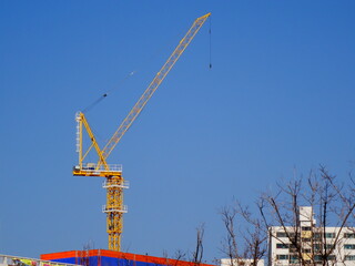 Fototapeta na wymiar Blue sky and yellow construction crane