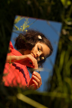 Reflection of a beautiful girl in a mirror 