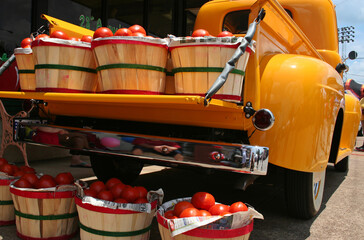 Vintage Yellow Truck with baskets of Red Tomatoes