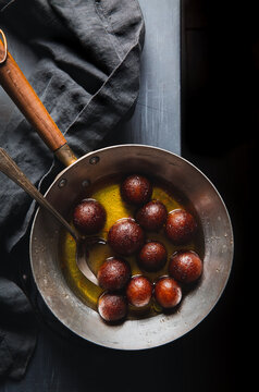 Indian dessert gulab jamuns in a pan