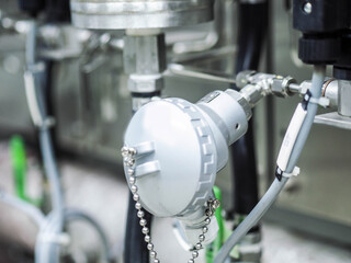 Temperature sensor for measuring instrument close up in industry zone at power plant.