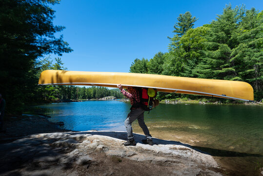 Man Portaging Kevlar Ultralight Canoe on Backcountry Canoe Trip
