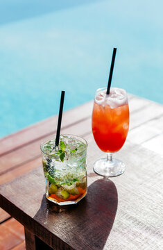 Summer poolside mojito and tequila sunrise cocktails 