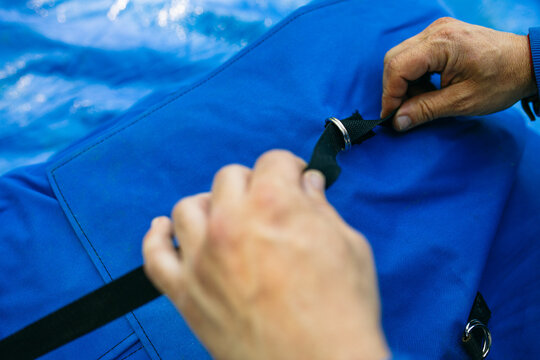 Crop hiker preparing gear during trip 