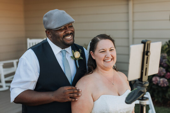 Bride And Groom Interacting With Guests At Social Distance Wedding During COVID