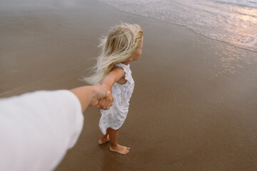A little girl holding on tight to her mother