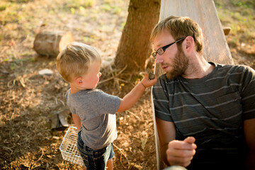 boy offers his father a rock