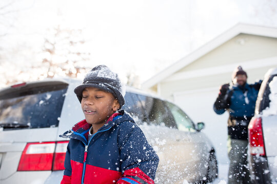 Boy reacts to being hit with snowball from dad