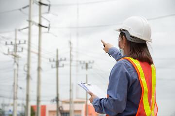 Hand holding clipboard and write on document checklist high voltage system, Working woman