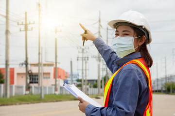 Hand holding clipboard and write on document checklist high voltage system, Working woman