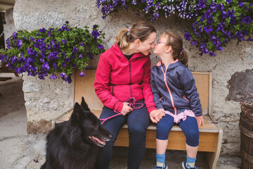 Loving mother and daughter with their dog