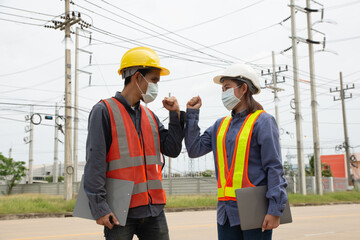 team of electrical engineers inspects the quality of the installation of high voltage poles